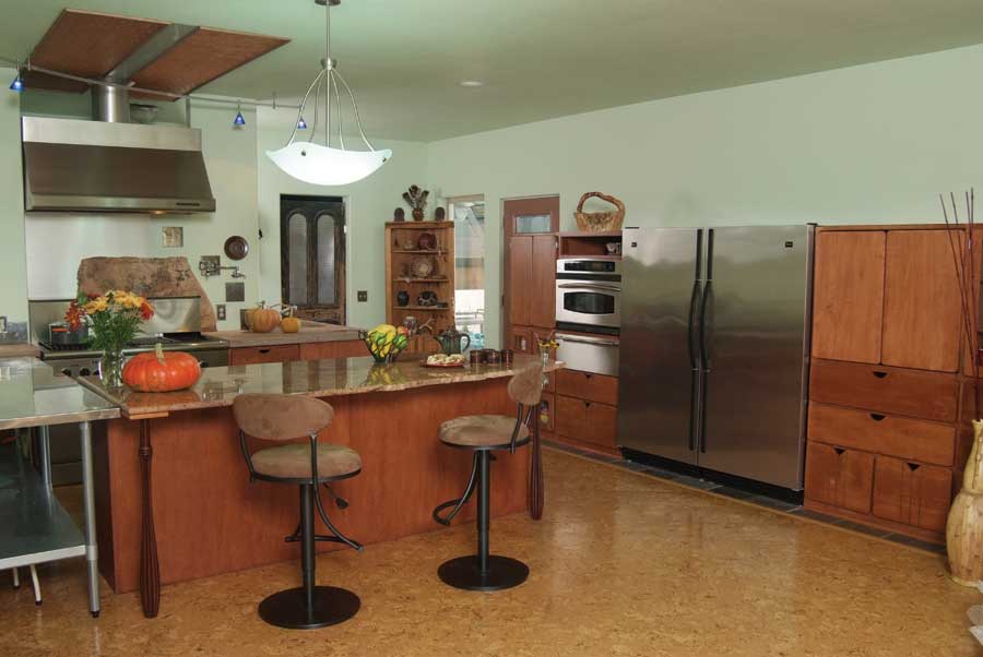 Sleek marble and efficient appliances juxtapose rough edges and antique wood doors in the modern-meets-traditional kitchen.